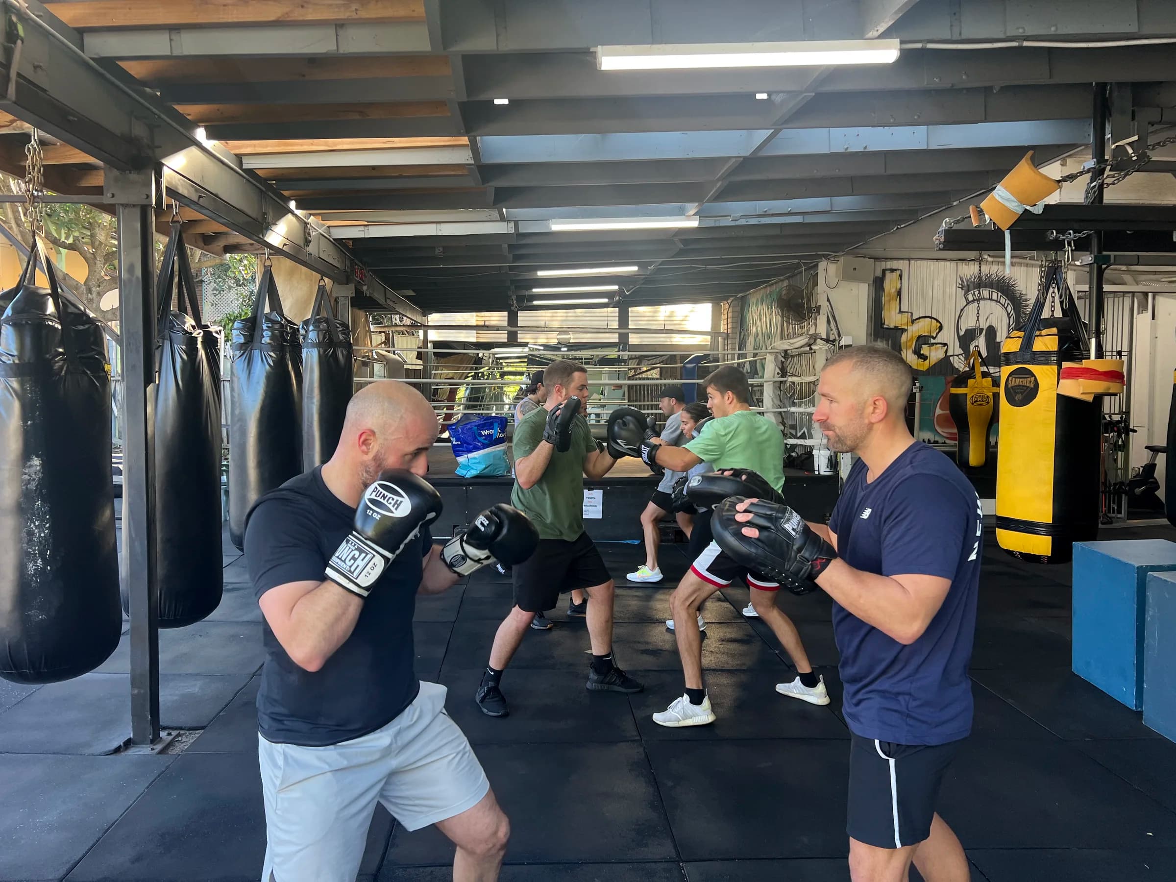 Boxers practising padwork during a training session at Legends Gym